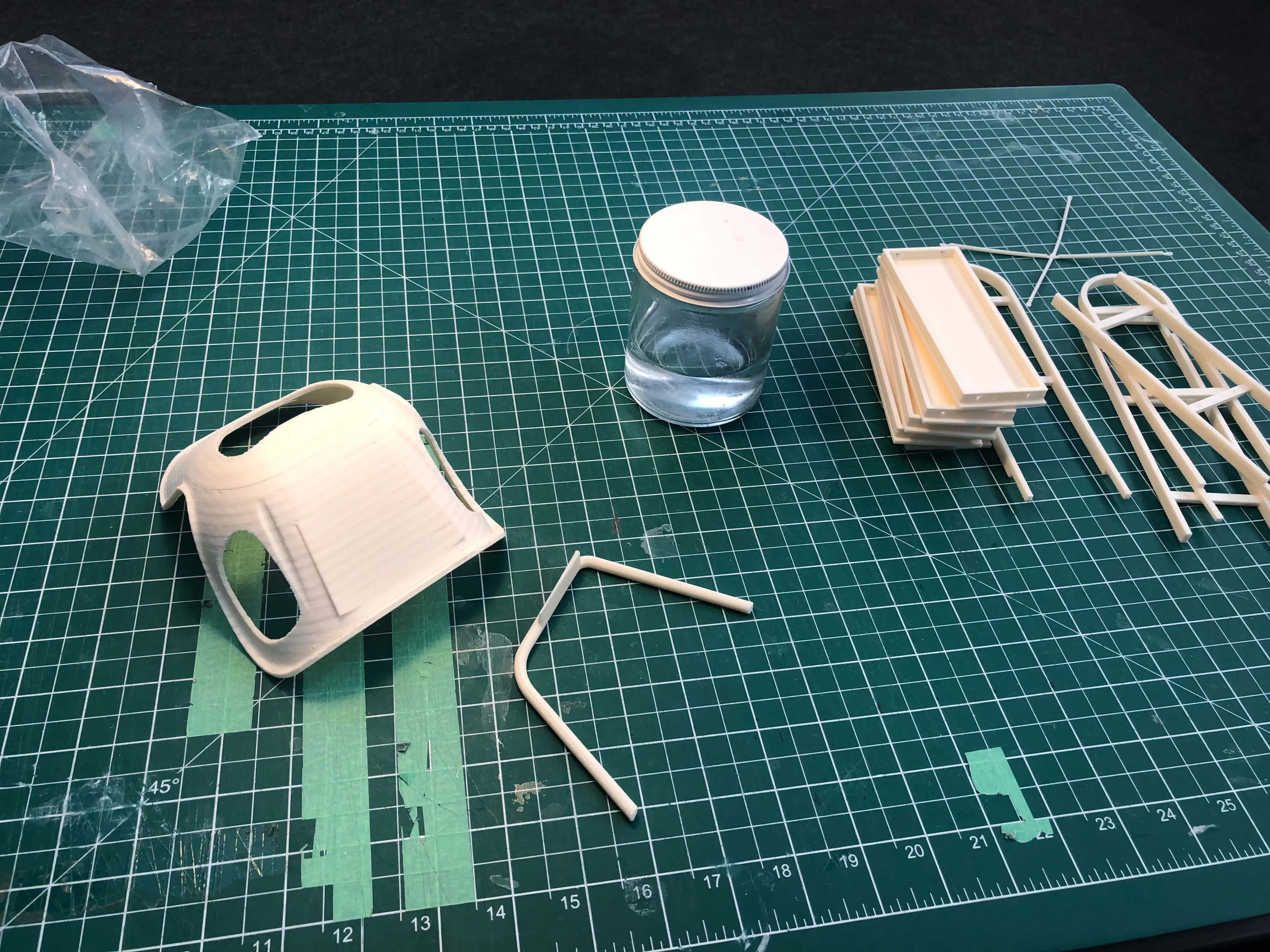 3D printed miniature chair models on a cutting mat